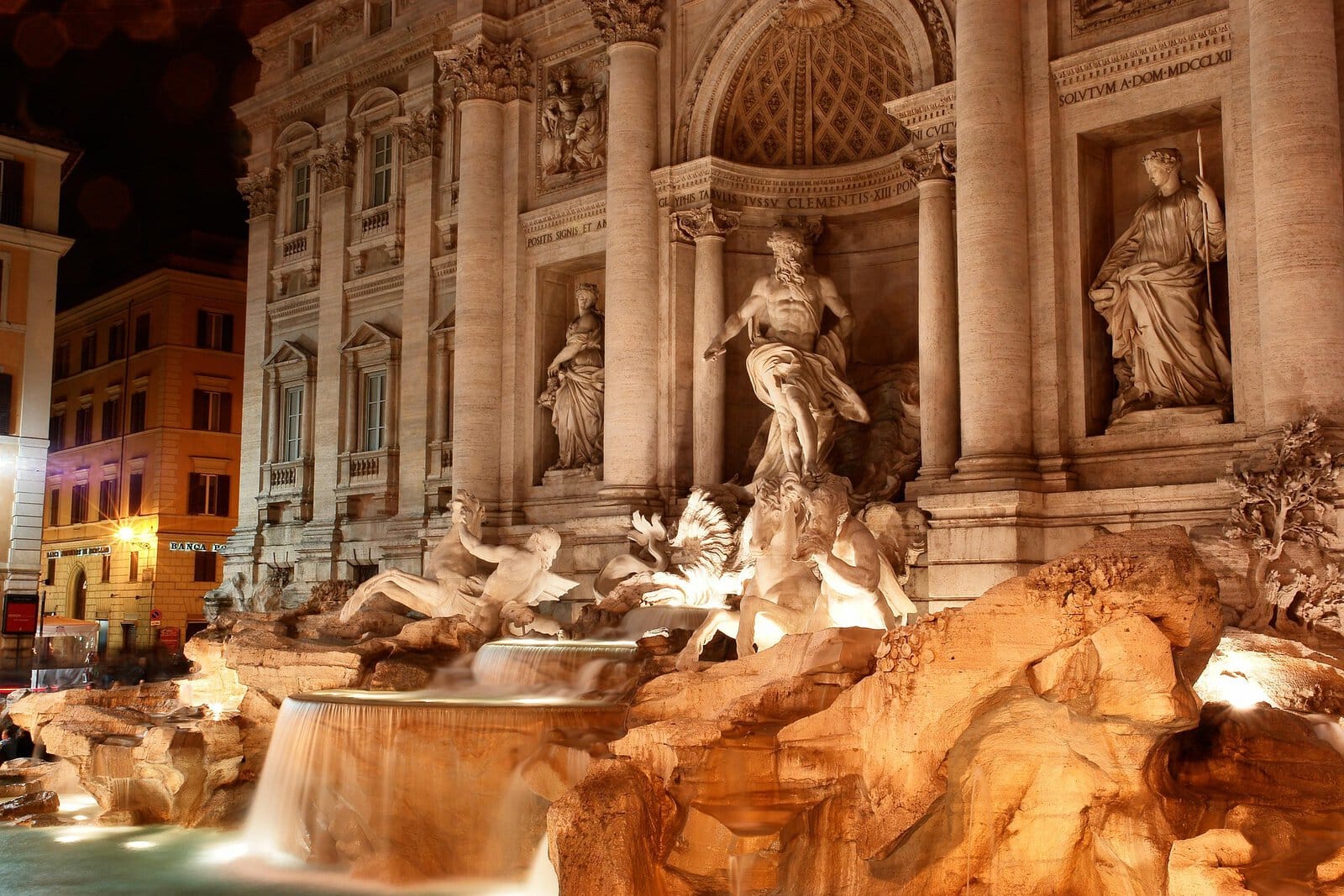 Der barocke Trevi-Brunnen in Rom, angestrahlt am frühen Morgen ohne Menschenmassen.